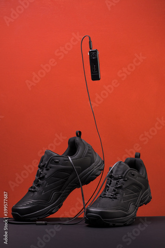 a pair of black sneakers on a colored background with music