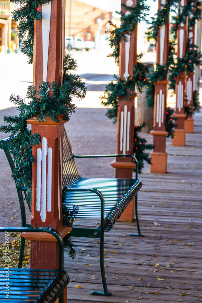 Obraz premium An old bench on a wooden sidewalk with holiday decorations