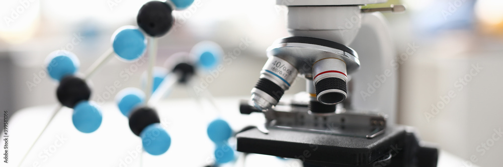 Close-up of modern device for laboratory investigation. Black and white equipment on working table. Tool to examine sample material. Light room. Lab and science concept Close-up of modern device for laboratory investigation. Black and white equipment on working table. Tool to examine sample material. Light room. Lab and science concept
