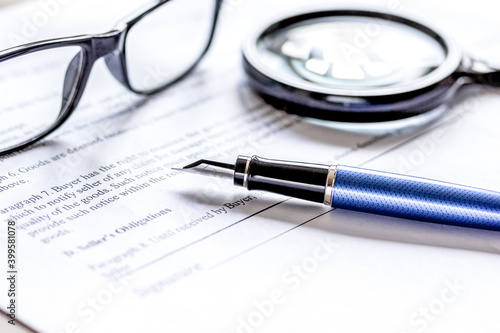 office desk with signing contract, glasses, magnifier and pen for business