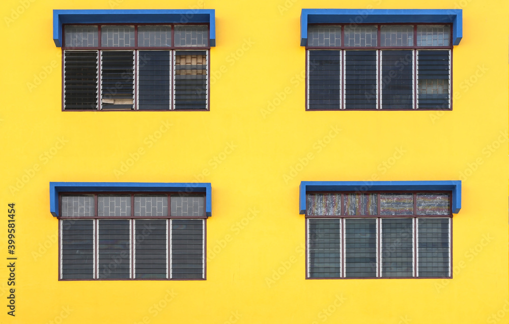 4 windows with a yellow background and painted blue windows