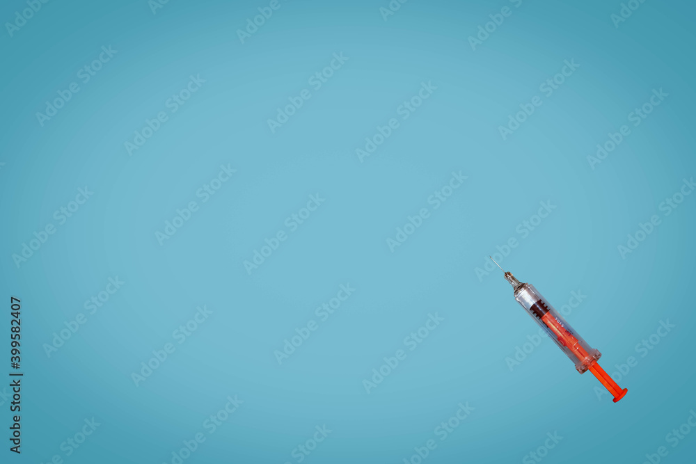 syringe on a blue background syringe on a blue background