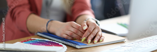 Close-up of womans hands laying on documents. Well-dressed lady posing in office. Creative design agency. Young female with beautiful manicure. Business concept