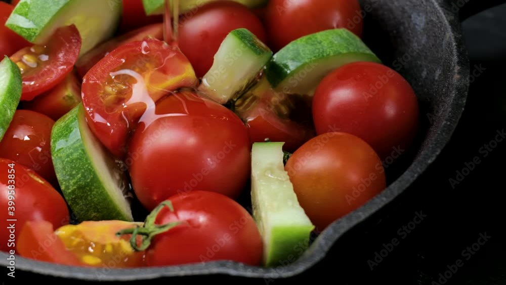 Salad with tomatoes, olives oil, and cucumber on an iron plate, Fresh organic salad, Raw snack vegetable with olives oil as antipasti, Vegetable salad with cherry tomatoes on a dark background. Salad with tomatoes, olives oil, and cucumber on an iron plate, Fresh organic salad, Raw snack vegetable with olives oil as antipasti, Vegetable salad with cherry tomatoes on a dark background.
