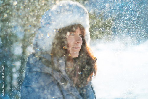 Woman surrounded by snowflakes at winter time  close up.
