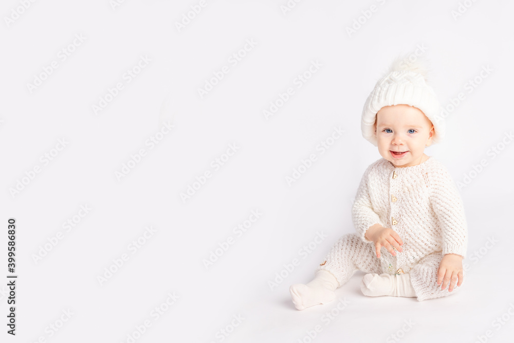 baby in a warm suit and hat on a white isolated background, space for text baby in a warm suit and hat on a white isolated background, space for text