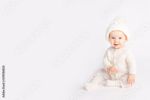 baby in a warm suit and hat on a white isolated background, space for text
