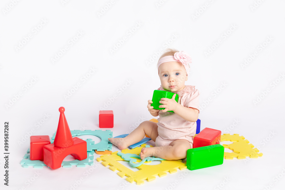 the kid plays with cubes on a white isolated background, space for text the kid plays with cubes on a white isolated background, space for text