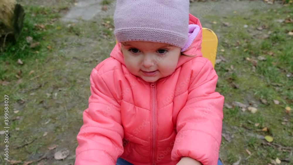 Cheerful toddler girl playing at children playground. Slow motion. Cheerful toddler girl playing at children playground. Slow motion.