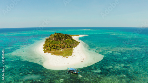 Small tropical island in the blue sea with a coral reef and the beach, top view. Summer and travel vacation concept. Canimeran Island, Balabac, Palawan, Philippines. photo