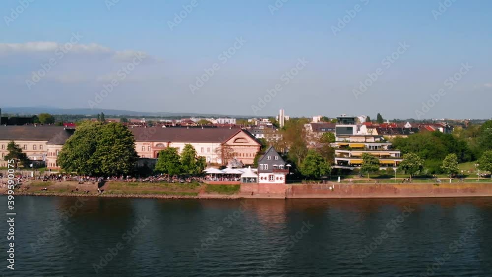 Aerial view of the coastline of Mainz city, during golden hour, in Germany - low, sideways, drone shot