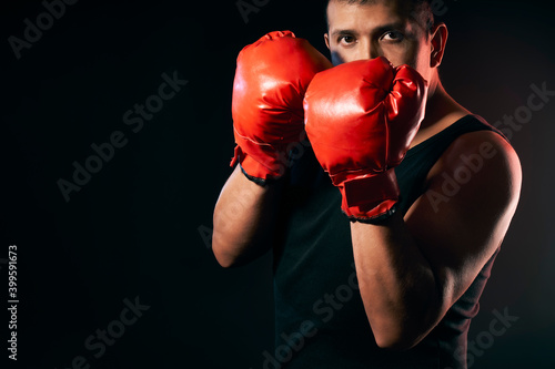 A middle aged latino male boxer uses boxing gloves to exercise and train for boxing © Graphic PhotoArt