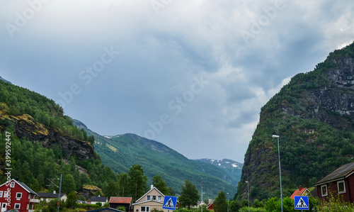 The beautiful and typical norwegian village of Flam with colorful houses and Sognefjord mountain landscape