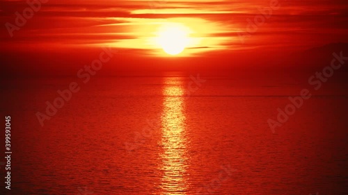 Seascape. Red sunset over sea water surface. View from cliffs of Maro Cerro Gordo Natural Park, Malaga province, Costa Del Sol, Andalusia, Spain. photo