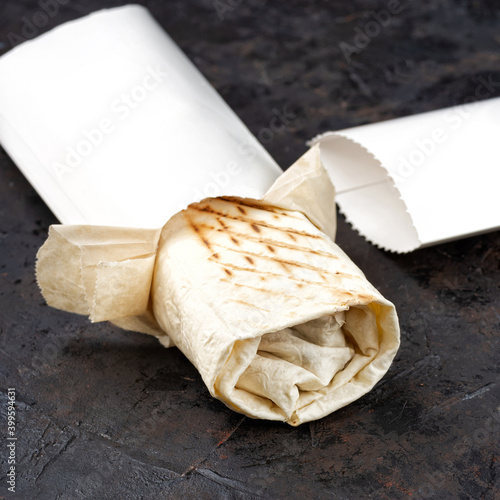 traditional oriental shawarma in Eco-friendly cardboard. dark stone surface. concept of eco packages of recyclables.