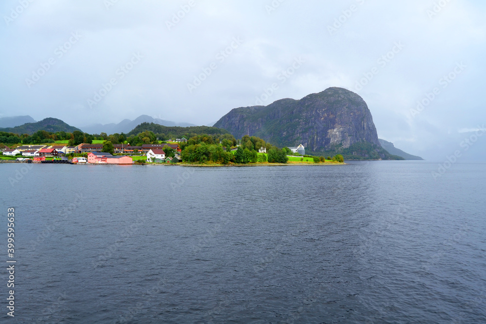 Norwegian fjord and mountains in rainy summer day. Mountain rural landscape village view during a boat trip, Lysefjord, Norway. 