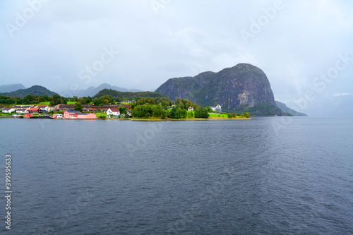 Norwegian fjord and mountains in rainy summer day. Mountain rural landscape village view during a boat trip, Lysefjord, Norway.  © Zhanko