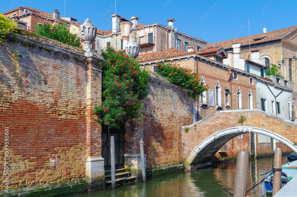 Venice, Italy. Small private bridge over the channel on background of old houses