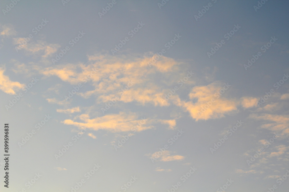 Pink clouds illuminated by the sun at dawn or sunset. Evening or morning dramatic sky Pink clouds illuminated by the sun at dawn or sunset. Evening or morning dramatic sky