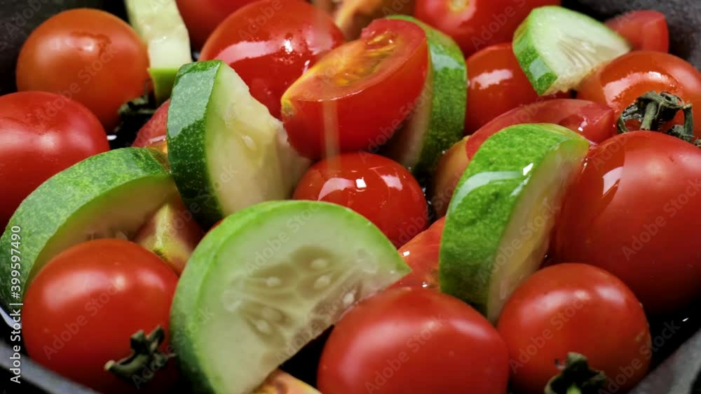 Salad with tomatoes, olives oil, and cucumber on an iron plate, Fresh organic salad, Raw snack vegetable with olives oil as antipasti, Vegetable salad with cherry tomatoes on a dark background. Salad with tomatoes, olives oil, and cucumber on an iron plate, Fresh organic salad, Raw snack vegetable with olives oil as antipasti, Vegetable salad with cherry tomatoes on a dark background.