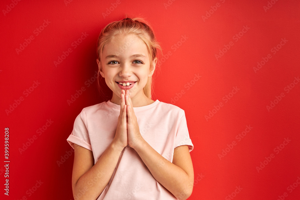 child girl over isolated red background begging and praying with hands together, girl stand with hope expression on face very emotional and worried child girl over isolated red background begging and praying with hands together, girl stand with hope expression on face very emotional and worried