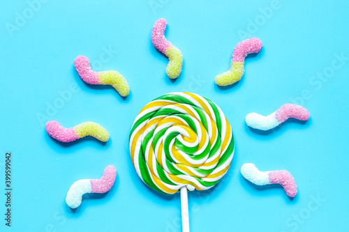 lollipop design with sugar candys on blue background top view mockup photo