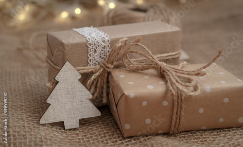 Winter holidays gift boxes on jute background. Eco friendly and zero waste gift packaging