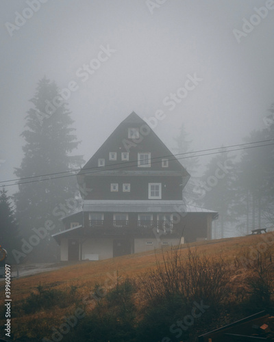 house in the foggy mountains