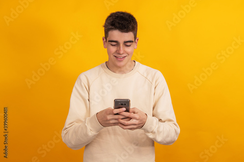 teenager with mobile phone or smartphone isolated on background © carballo