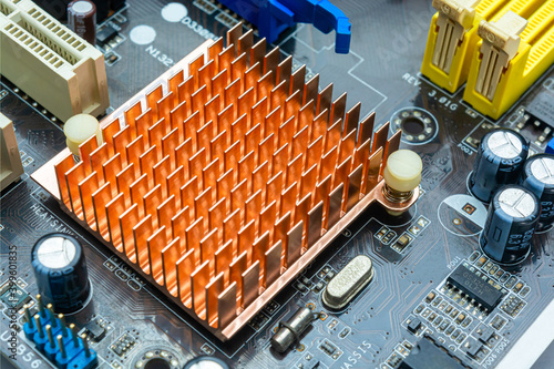 Close up view of copper heat sink or radiator on computer motherboard.