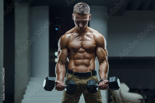 Caucasian man pumping up muscles. fitness training