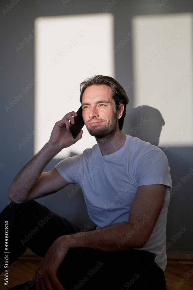 Attractive young man talking on his phone Attractive young man talking on his phone