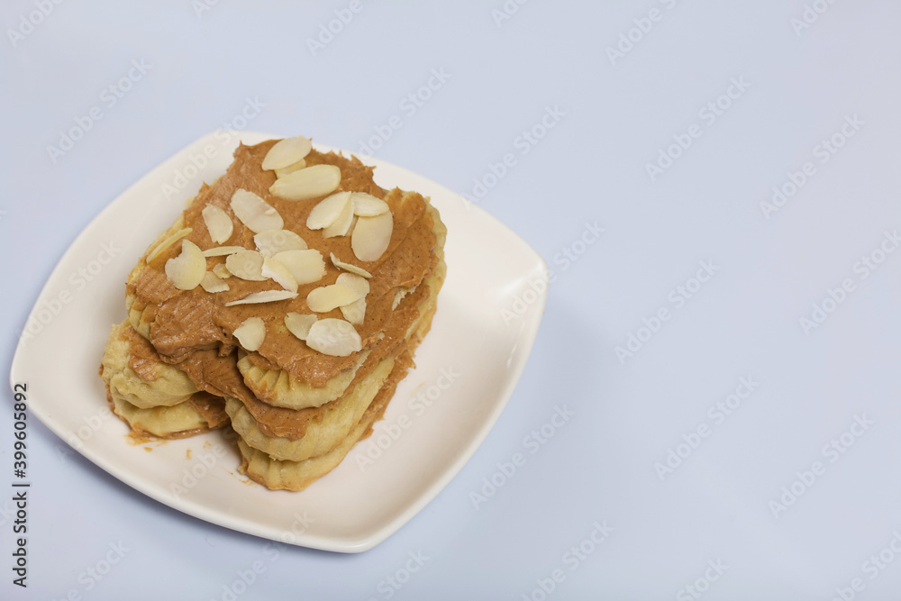 Eclairs cake smeared with cinnamon cream. On a white surface. Eclairs cake smeared with cinnamon cream. On a white surface.