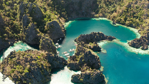 Tourist boats around the beautiful big and small lagoons, aerial view. lagoon, mountains covered with forests.coves with blue water among the rocks. Seascape, tropical landscape. Palawan, Philippines © Alex Traveler