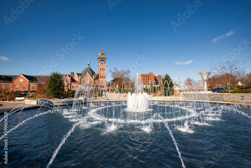 Photography A beautiful fountain in a small city park with a brilliant blue sky