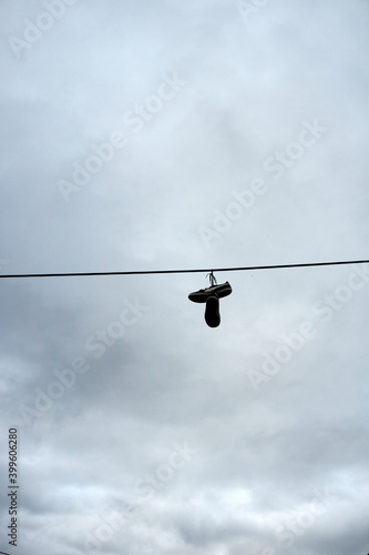 A pair of shoes hanging on a wire