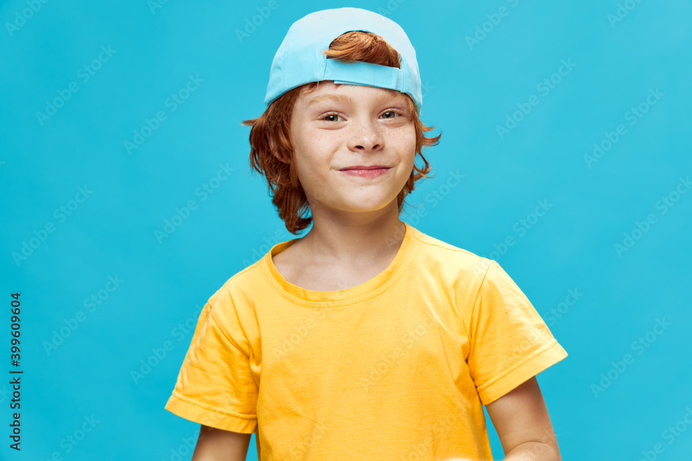 Cheerful boy blue cap on his head yellow t-shirt smile 