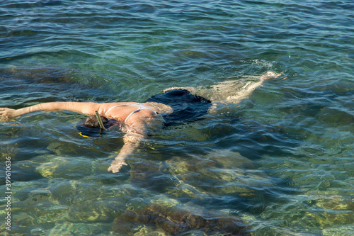 Adult woman diving into clear water of sea © scullery