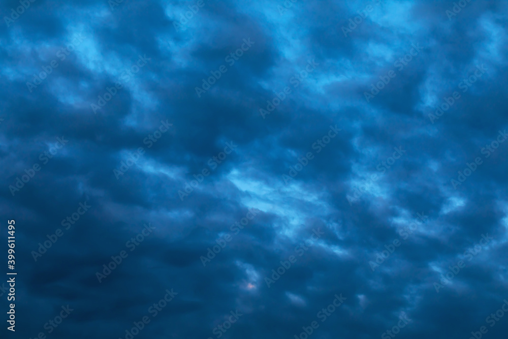Defocused sky texture with dark rain clouds for use as background