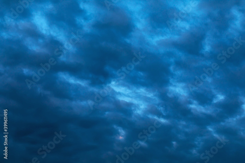Defocused sky texture with dark rain clouds for use as background