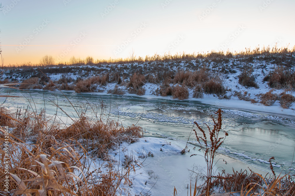 Fototapeta premium Colourful landscape with snowy trees, beautiful frozen river.