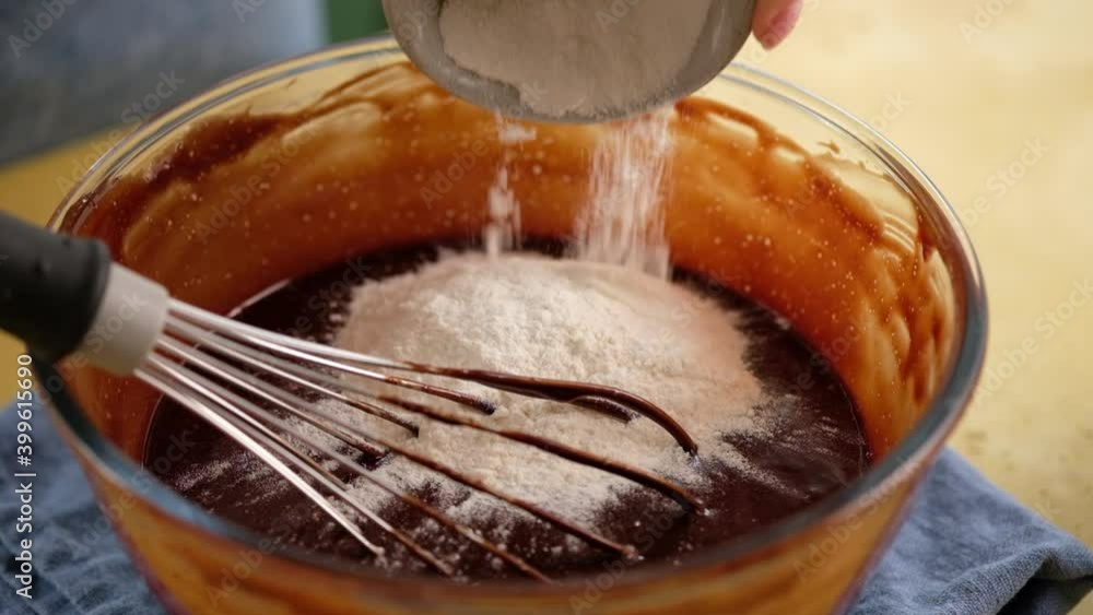 Close-up of female hands preparing the dough for a chocolate cake. Cooking brownies. Chocolate cream for a cake. Close-up of female hands preparing the dough for a chocolate cake. Cooking brownies. Chocolate cream for a cake.