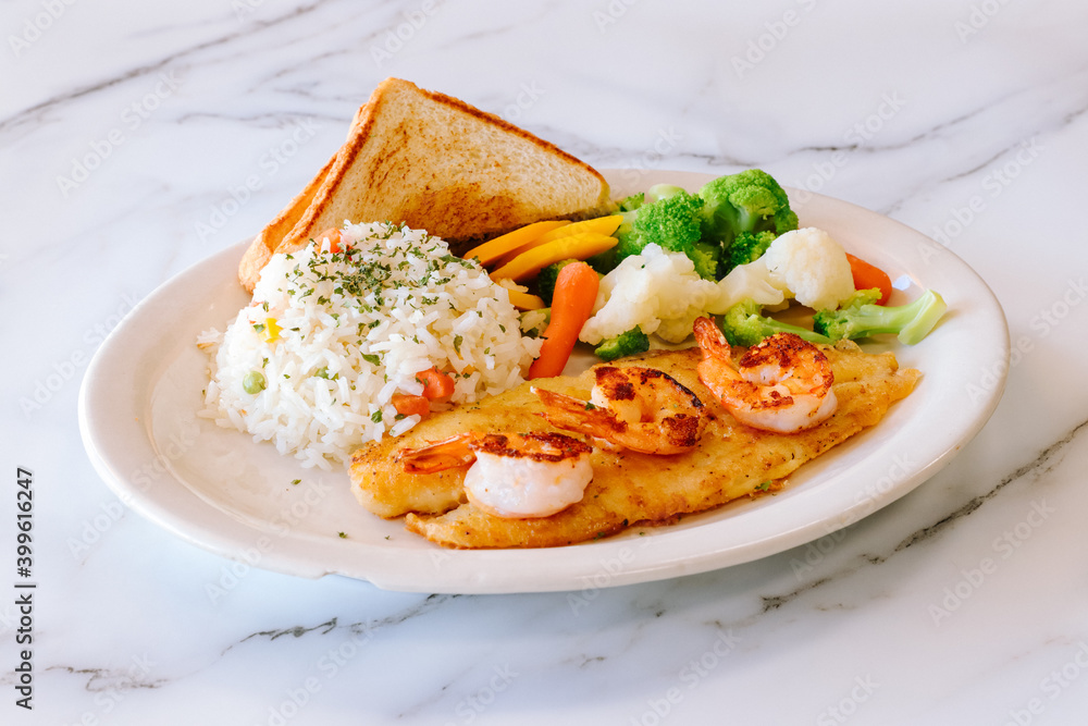 Mexican food grilled fish with shrimp steamed vegetables rice and toast