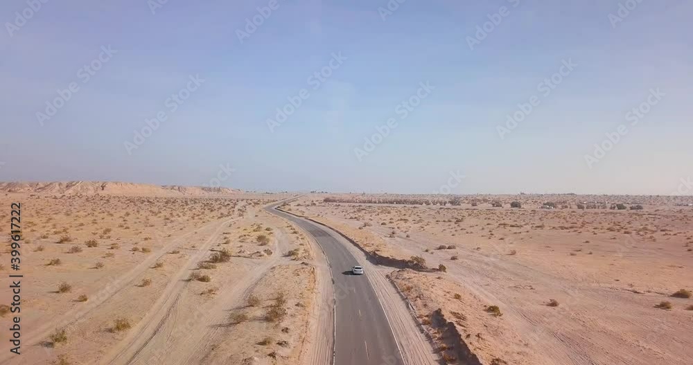 Car driving down a desert road Car driving down a desert road