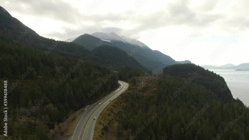 Sea to Sky Hwy in Howe Sound near Squamish, British Columbia, Canada. Aerial panoramic View. Beautiful Sunny and Cloudy Morning Sky.