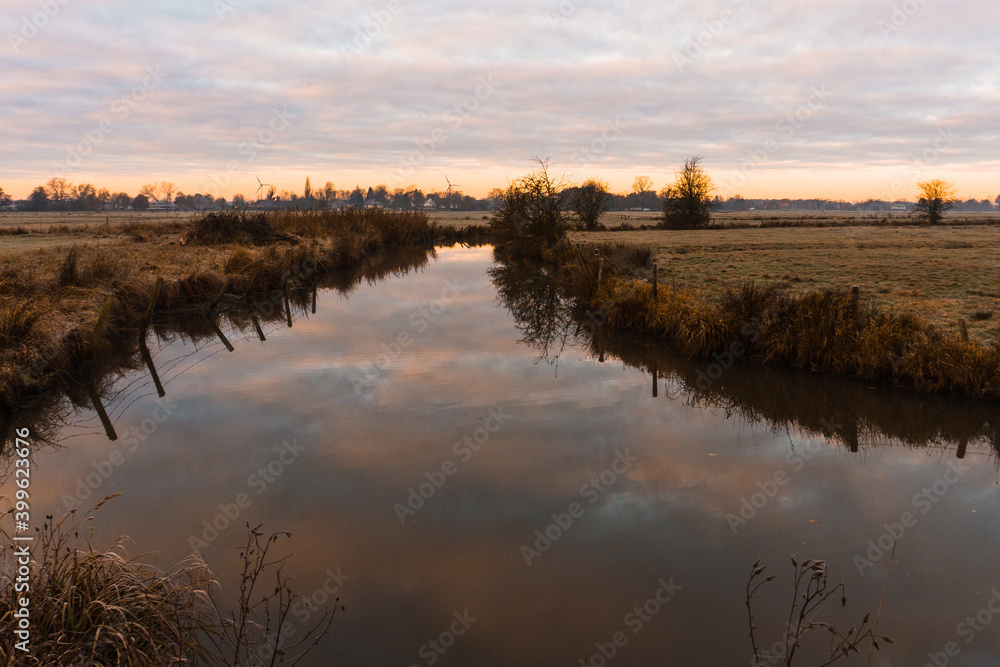 sunrise over the river in a cold winter morning, wide landscape