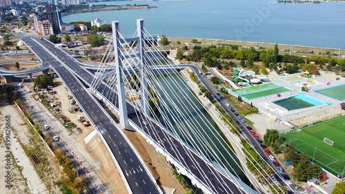 Ciurel passage, bridge over a river with moving cars, recreational complex, lake. View from the drone. Bucharest, Romania photo