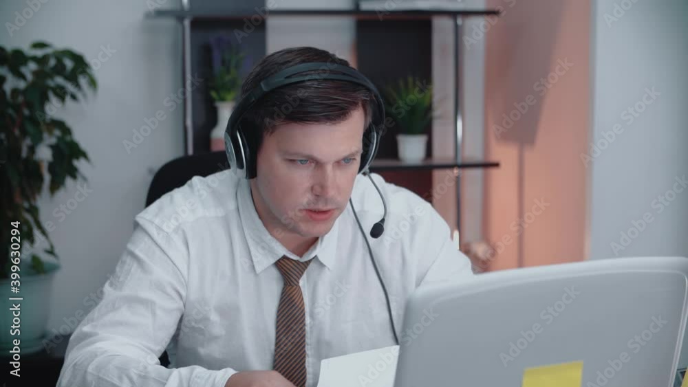 The support representative speaks confidently with the webcam. A businessman in a headset communicates via video conference call. The hotline manager is talking to the client. The support representative speaks confidently with the webcam. A businessman in a headset communicates via video conference call. The hotline manager is talking to the client.