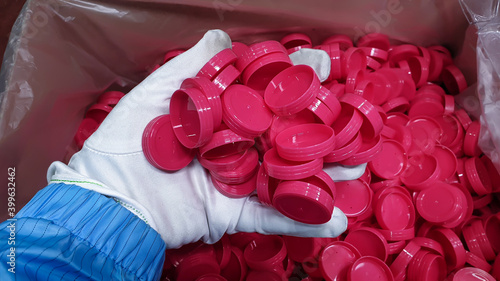 red plastic bottle cap.photo of plastic injection parts on site of plastic factory, in plastics industry. photo