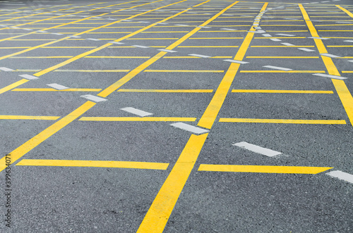 Yellow road road marking on grey asphalt © Galina